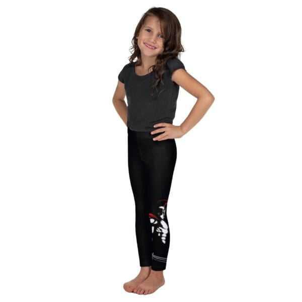 A little girl in MW Combatives Kid's Spats posing against a white background.
