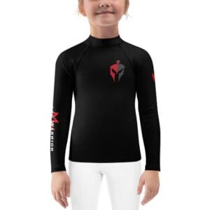 A little girl wearing a black long-sleeved MW Combatives Kids Rash Guard with a red logo.
