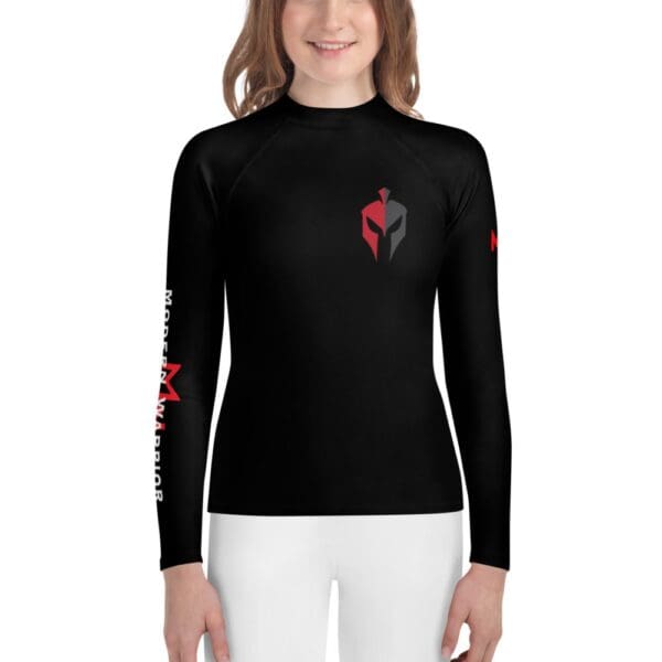 A girl wearing a MW Combatives Youth Rash Guard.