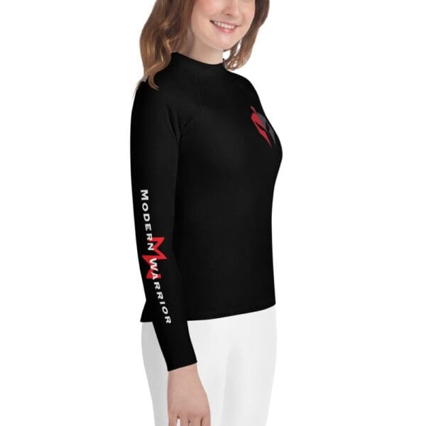 A girl wearing a MW Combatives youth rash guard.