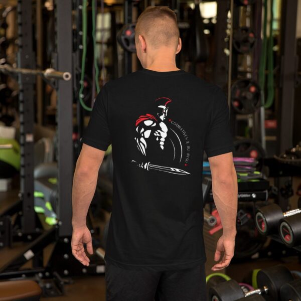 A man in a gym wearing a black MW Combative Basic T-Shirt.