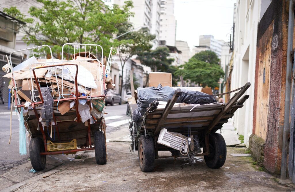 Poverty abounds. Shot of carts full of garbage in the street of a poor neighbourhood.