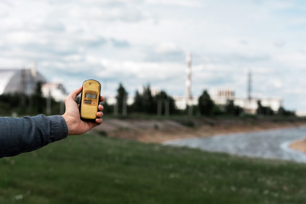 PRIPYAT, UKRAINE - AUGUST 15, 2019: cropped view of man holding radiometer near chernobyl nuclear