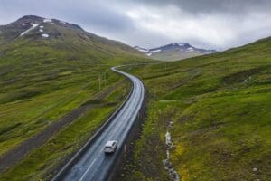 Lonely rent car drive on remote road with beautiful scenery of Iceland