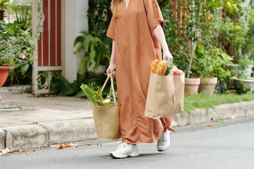 Woman carrying two bags of groceries