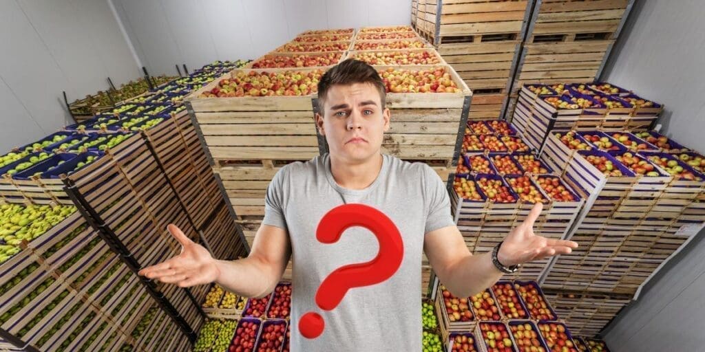 Man looking confused in a food storage room full of apple crates, facing a classic prepper dilemma.